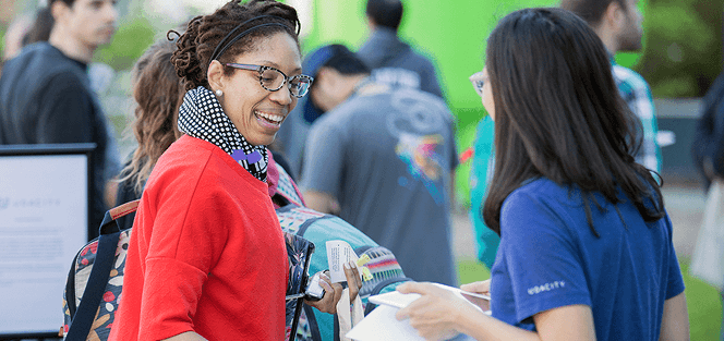 A Udacity learner smiling at a community event.